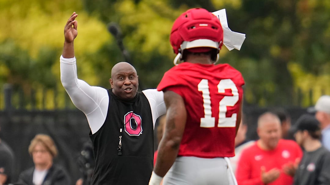 Ohio State Buckeyes running backs coach Carlos Locklyn works with running back CJ Donaldson (12) during the first football practice of the season at the Woody Hayes Athletic Center on July 31, 2025.