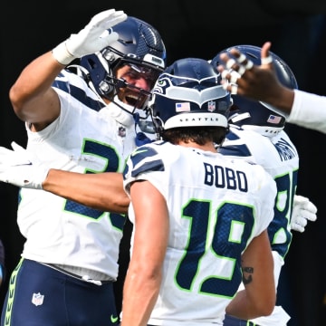 Aug 10, 2024; Inglewood, California, USA; Seattle Seahawks running back George Holani (36) celebrates with teammates after making a touchdown against the Los Angeles Chargers during the second quarter at SoFi Stadium. Mandatory Credit: Jonathan Hui-USA TODAY Sports