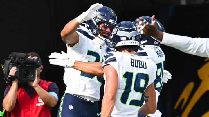 Aug 10, 2024; Inglewood, California, USA; Seattle Seahawks running back George Holani (36) celebrates with teammates after making a touchdown against the Los Angeles Chargers during the second quarter at SoFi Stadium. Mandatory Credit: Jonathan Hui-USA TODAY Sports