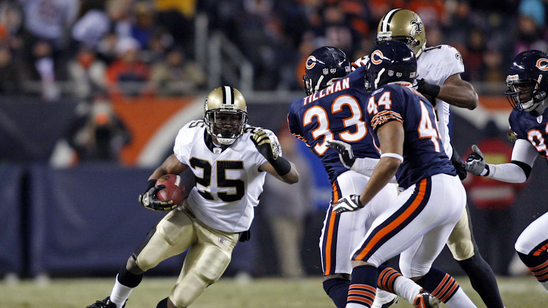 Dec 11, 2008; Chicago, IL, USA; New Orleans Saints running back Reggie Bush (25) runs with the ball as Chicago Bears cornerback Charles Tillman (33) and safety Kevin Payne (44) come in for the tackle during the first quarter at Soldier Field. Mandatory Credit: Jerry Lai-Imagn Images