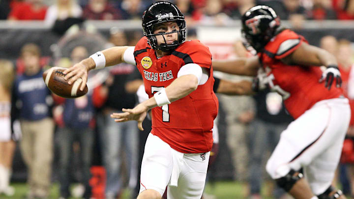 Dec 28, 2012; Houston, TX, USA; Texas Tech Red Raiders quarterback Seth Doege (7) looks for an open receiver against the Minnesota Golden Gophers during the second quarter of the Car Care Bowl at Reliant Stadium. Mandatory Credit: Troy Taormina-Imagn Images
