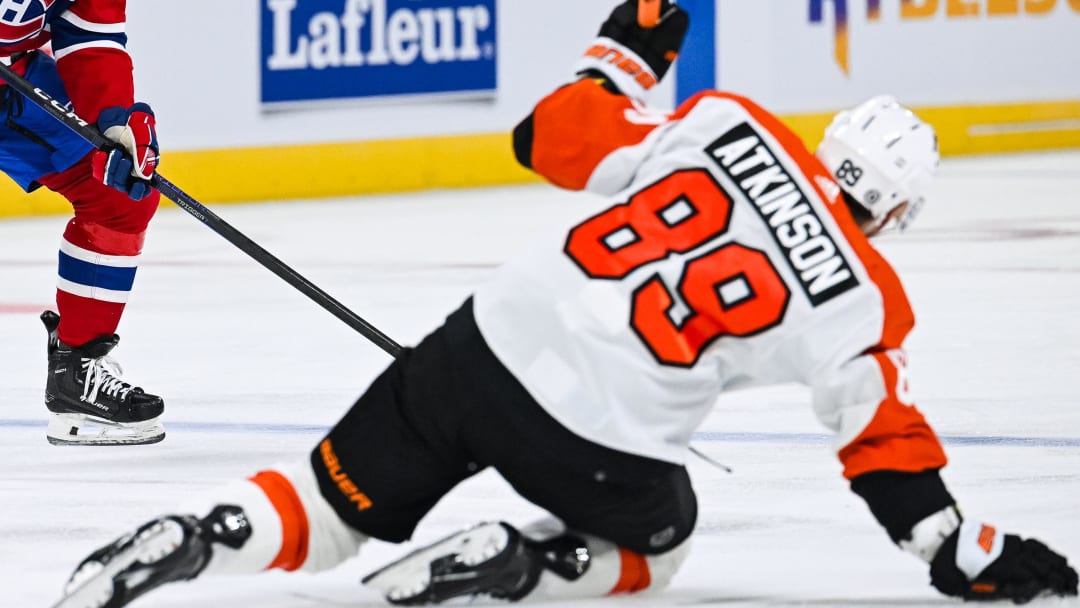 Mar 28, 2024; Montreal, Quebec, CAN; Montreal Canadiens defenseman Jordan Harris (54) plays the puck against Philadelphia Flyers right wing Cam Atkinson (89) during the second period at Bell Centre. Mandatory Credit: David Kirouac-USA TODAY Sports