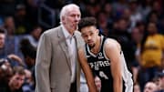 Apr 16, 2019; Denver, CO, USA; San Antonio Spurs head coach Gregg Popovich talks with guard Derrick White (4) in the second quarter against the Denver Nuggets in game two of the first round of the 2019 NBA Playoffs at the Pepsi Center.