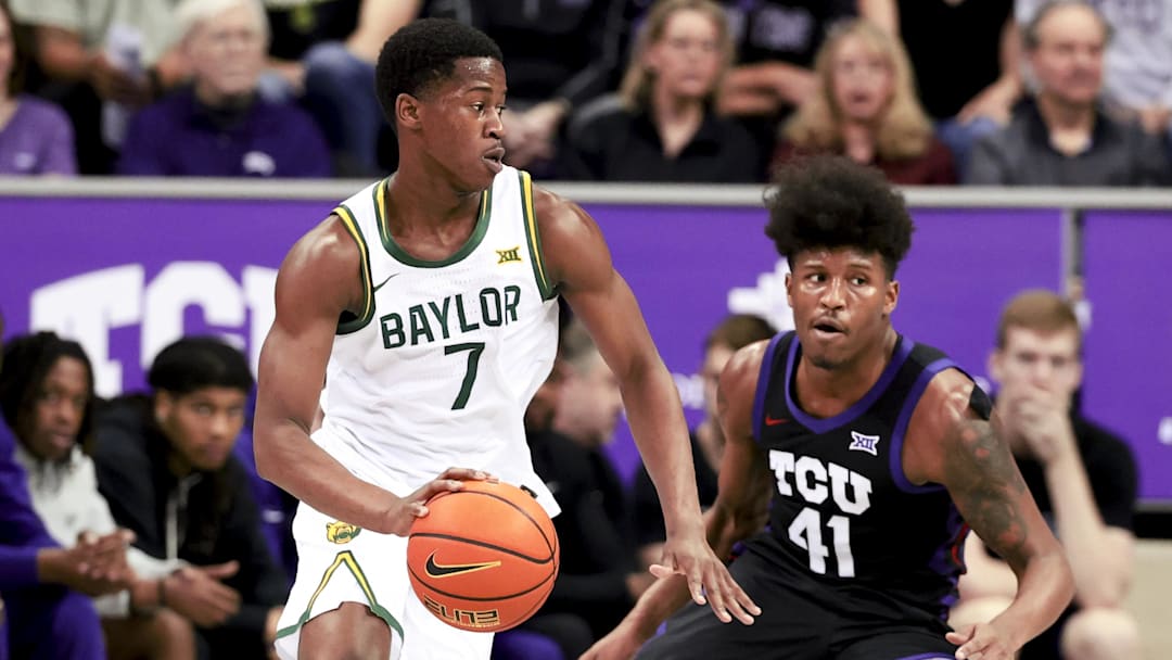 Mar 4, 2025; Fort Worth, Texas, USA;  Baylor Bears guard VJ Edgecombe (7) controls the ball as TCU Horned Frogs guard Jace Posey (41) defends during the first half at Ed and Rae Schollmaier Arena. Mandatory Credit: Kevin Jairaj-Imagn Images