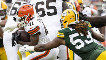 Cleveland Browns running back John Kelly Jr. (41) runs the ball as Green Bay Packers defensive end Arron Mosby (53) tackles him during the third quarter at Cleveland Browns Stadium. 