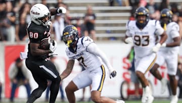 Nov 1, 2025; Houston, Texas, USA; Houston Cougars wide receiver Jaquise Martin (80) catches a pass against West Virginia Mountaineers safety Israel Boyce (7)  in the second half at TDECU Stadium. Mandatory Credit: Thomas Shea-Imagn Images