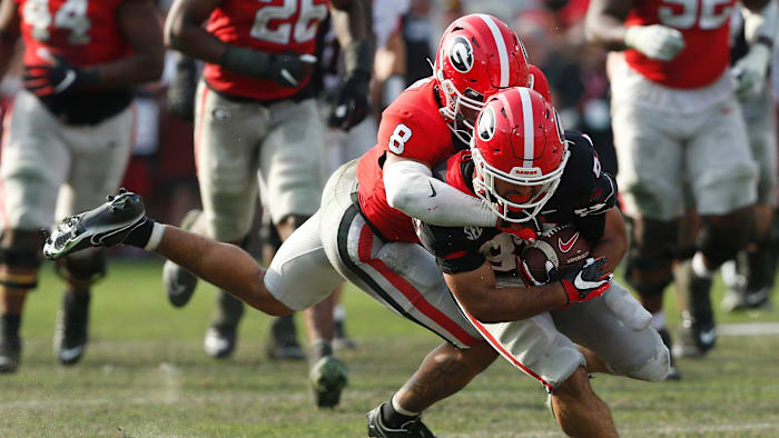 Georgia defensive back Joenel Aguero (8) tackles Georgia wide receiver Mekhi Mews (87) during the