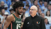 Feb 26, 2024; Chapel Hill, North Carolina, USA; Miami (Fl) Hurricanes forward Norchad Omier (15) with head coach Jim Larranaga in the second half at Dean E. Smith Center. Mandatory Credit: Bob Donnan-USA TODAY Sports