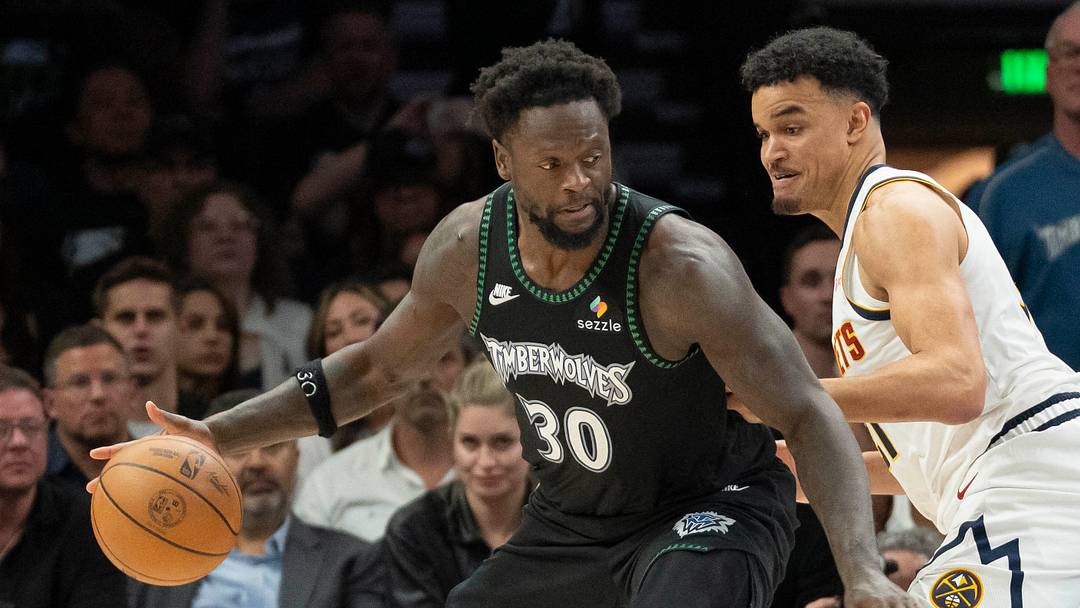 Apr 30, 2026; Minneapolis, Minnesota, USA; Minnesota Timberwolves forward Julius Randle (30) dribbles the ball as Denver Nuggets forward Spencer Jones (21) plays defense in the second half during game six of the first round of the 2026 NBA Playoffs at Target Center. Mandatory Credit: Jesse Johnson-Imagn Images