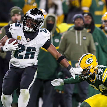Philadelphia Eagles running back Saquon Barkley (26) spins out of a tackle by Green Bay Packers cornerback Carrington Valentine (24) on Monday, November 10, 2025, at Lambeau Field in Green Bay, Wis. The Eagles won the game, 10-7.