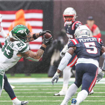 Sep 24, 2023; East Rutherford, NJ; New York Jets tight end Tyler Conklin (83) makes a catch in front of New England Patriots safety Kyle Dugger (23) and safety Jabrill Peppers (5) during the second half at MetLife Stadium 