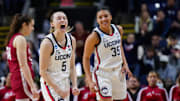 Mar 26, 2022; Bridgeport, CT, USA; UConn Huskies guard Paige Bueckers (5) and guard Azzi Fudd (35) react after a play against the Indiana Hoosiers during the second half in the Bridgeport regional semifinals of the women's college basketball NCAA Tournament at Webster Bank Arena. Mandatory Credit: David Butler II-Imagn Images
