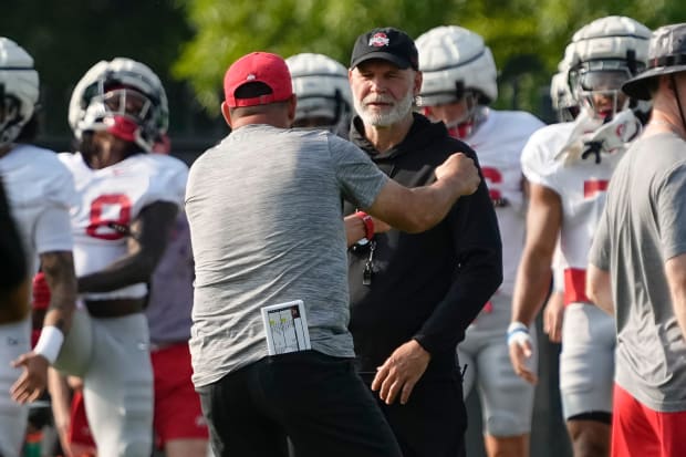 Coaches talk during practice.