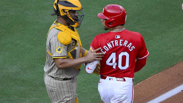 Jul 25, 2025; St. Louis, Missouri, USA;  St. Louis Cardinals first baseman Willson Contreras (40) is held back by San Diego Padres third baseman Jose Iglesias (7) after he was hit by a pitch from starting pitcher Nick Pivetta (not pictured) during the second inning at Busch Stadium. Mandatory Credit: Jeff Curry-Imagn Images