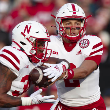 Nov 20, 2021; Madison, Wisconsin, USA;  Nebraska Cornhuskers quarterback Adrian Martinez (2) hands the football off to running back Markese Stepp (30) during the first quarter against the Wisconsin Badgers at Camp Randall Stadium.