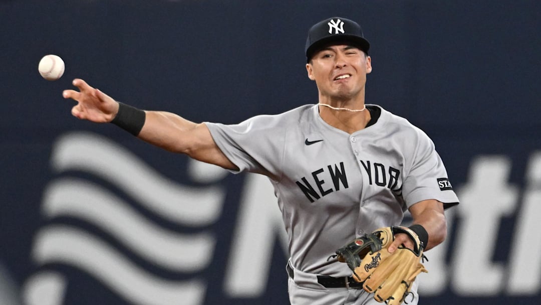 Jul 22, 2025; Toronto, Ontario, CAN;   New York Yankees shortstop Anthony Volpe (11) makes a throwing error against the Toronto Blue Jays in the sixth inning at Rogers Centre. Mandatory Credit: Dan Hamilton-Imagn Images