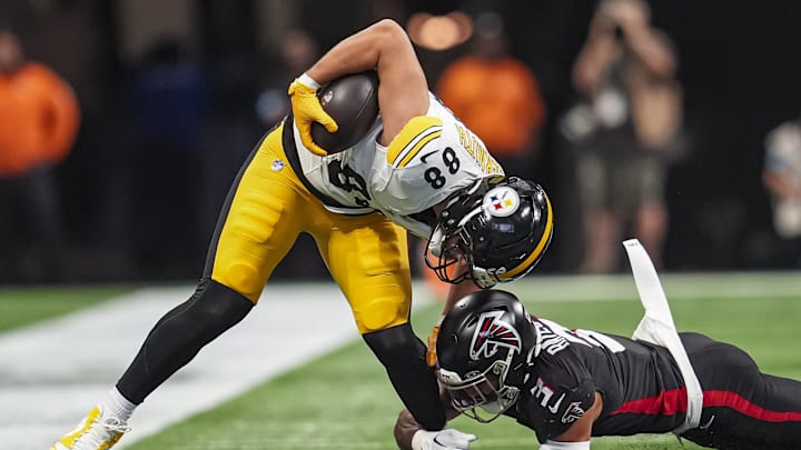 Sep 8, 2024; Atlanta, Georgia, USA; Pittsburgh Steelers tight end Pat Freiermuth (88) is tackled by Atlanta Falcons safety Jessie Bates III (3) during the first quarter at Mercedes-Benz Stadium. 