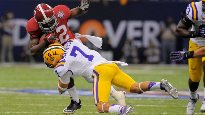 Jan 9, 2012; New Orleans, LA, USA; LSU Tigers cornerback Tyrann Mathieu (7) tackles Alabama Crimson Tide running back Eddie Lacy (42) during the first half of the 2012 BCS National Championship game at the Mercedes-Benz Superdome.  Mandatory Credit: John David Mercer-USA TODAY Sports