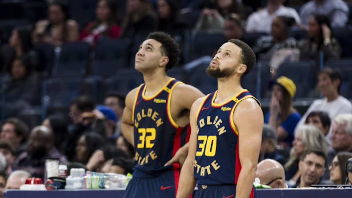 Stephen Curry and Trayce Jackson-Davis watch a replay during the fourth quarter against the Heat. Stephen Curry and Trayce Jackson-Davis watch a replay during the fourth quarter against the Heat.