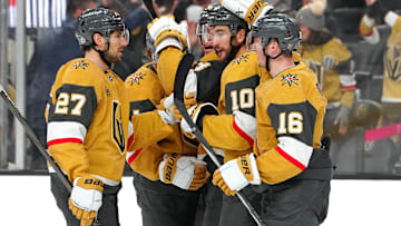 Dec 6, 2024; Las Vegas, Nevada, USA; Vegas Golden Knights center Nicolas Roy (10) celebrates with Vegas Golden Knights defenseman Shea Theodore (27) and Vegas Golden Knights left wing Pavel Dorofeyev (16) after scoring a goal against the Dallas Stars during the second period at T-Mobile Arena. Mandatory Credit: Stephen R. Sylvanie-Imagn Images