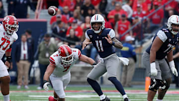 Nov 18, 2023; Tucson, Arizona, USA; Arizona Wildcats quarterback Noah Fifita (11) throws a pass against Utah Utes defensive end Van Fillinger (7) during the second half at Arizona Stadium. Mandatory Credit: Zachary BonDurant-Imagn Images