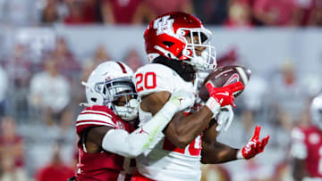 Sep 7, 2024; Norman, Oklahoma, USA;  Houston Cougars defensive back Jeremiah Wilson (20) makes an interception in front of Oklahoma Sooners wide receiver Zion Ragins (81) but it is called back for a penalty during the second half at Gaylord Family-Oklahoma Memorial Stadium. Mandatory Credit: Kevin Jairaj-Imagn Images