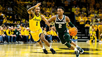 Michigan State guard Tyson Walker drives to the basket as Iowa guard Ahron Ulis defends Saturday,