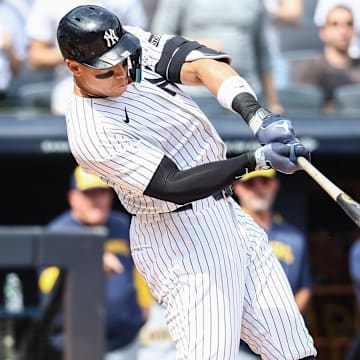 Mar 29, 2025; Bronx, New York, USA; New York Yankees right fielder Aaron Judge (99) hits a solo home run in the first inning against the Milwaukee Brewers at Yankee Stadium. 