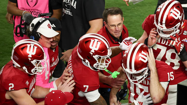 Jan 19, 2026; Miami Gardens, FL, USA; Indiana Hoosiers quarterback Fernando Mendoza (15) celebrates with head coach Curt Cignetti after scoring a touchdown against the Miami Hurricanes in the fourth quarter during the College Football Playoff National Championship game at Hard Rock Stadium. Mandatory Credit: Kim Klement Neitzel-Imagn Images