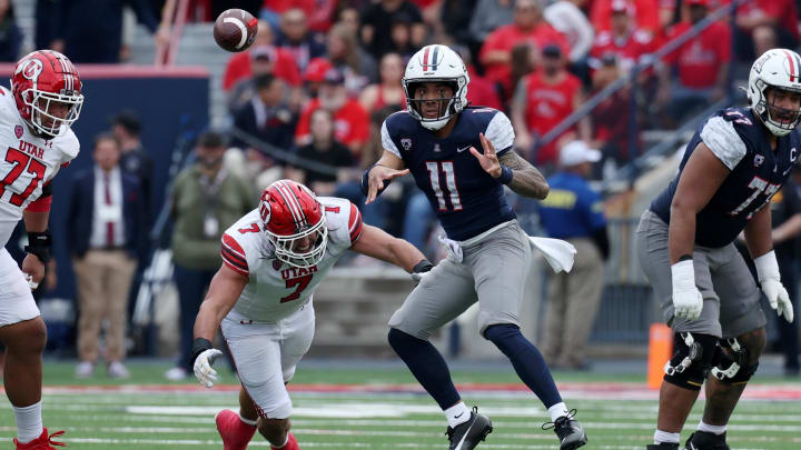 Nov 18, 2023; Tucson, Arizona, USA; Arizona Wildcats quarterback Noah Fifita (11) throws a pass against Utah Utes defensive end Van Fillinger (7) during the second half at Arizona Stadium. 