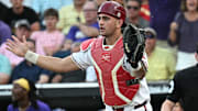 LSU Tigers shortstop Steven Milam (4) scores as Arkansas Razorbacks catcher Ryder Helfrick (27) holds the throw during the eighth inning at Charles Schwab Field.