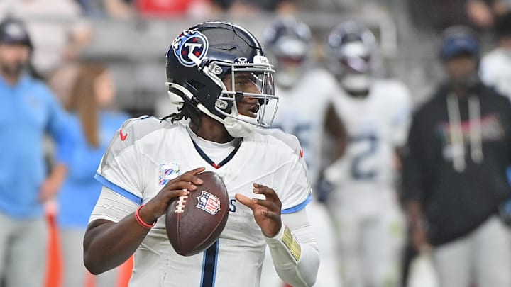 Oct 5, 2025; Glendale, Arizona, USA; Tennessee Titans quarterback Cam Ward (1) looks to throw against the Arizona Cardinals during the fourth quarter at State Farm Stadium. Mandatory Credit: Matt Kartozian-Imagn Images