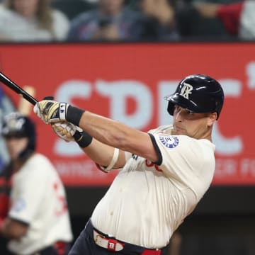 Aug 30, 2024; Arlington, Texas, USA; Texas Rangers first base Nathaniel Lowe (30) hits a solo home run in the second inning against the Oakland Athletics at Globe Life Field. 