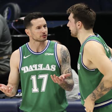 Former Dallas Mavericks guard and current Los Angeles Lakers coach Redick speaks with guard Luka Doncic during the second quarter against the New York Knicks at American Airlines Center. 