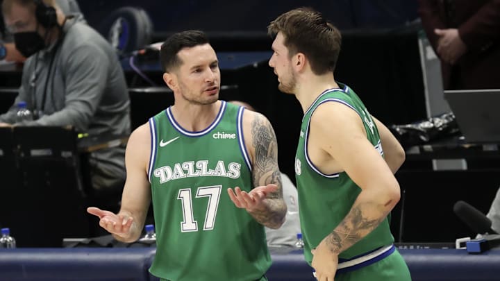 Former Dallas Mavericks guard and current Los Angeles Lakers coach Redick speaks with guard Luka Doncic during the second quarter against the New York Knicks at American Airlines Center. 