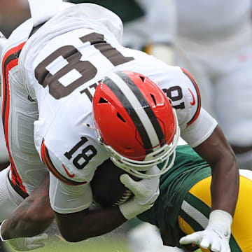 Cleveland Browns wide receiver David Bell (18) is upended by a Green Bay Packers defender during the first half of an NFL preseason football game at Cleveland Browns Stadium, Saturday, Aug. 10, 2024, in Cleveland, Ohio.