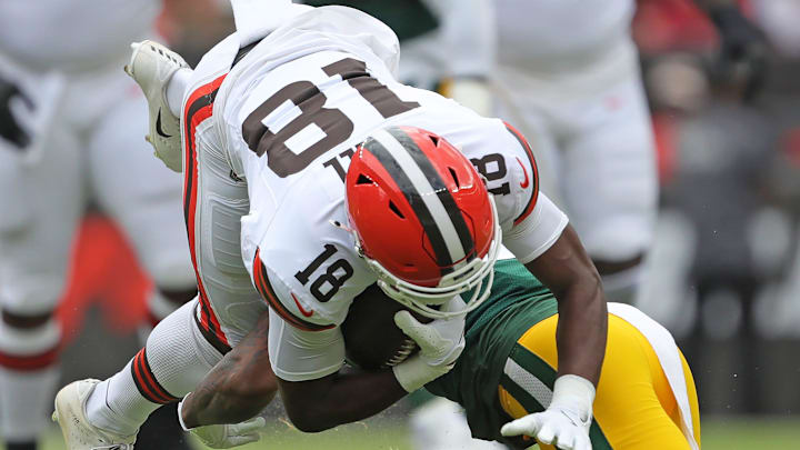 Cleveland Browns wide receiver David Bell (18) is upended by a Green Bay Packers defender during the first half of an NFL preseason football game at Cleveland Browns Stadium, Saturday, Aug. 10, 2024, in Cleveland, Ohio.