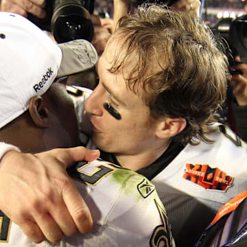Feb 7, 2010; Miami, FL, USA; New Orleans Saints quarterback Drew Brees (9) hugs running back Reggie Bush (25) after Super Bowl XLIV against the Indianapolis Colts at Sun Life Stadium. The Saints won 31-17. Mandatory Credit: John David Mercer-Imagn Images