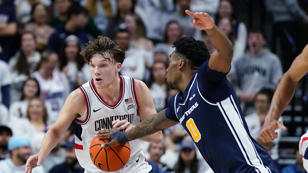 Dec 5, 2025; Storrs, Connecticut, USA; East Texas A&M Lions forward Ronnie Harrison (0) strips the ball from UConn Huskies guard Braylon Mullins (24) in the second half at Harry A. Gampel Pavilion. Mandatory Credit: David Butler II-Imagn Images
