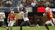Oct 18, 2025; Charlottesville, Virginia, USA; Washington State Cougars wide receiver Joshua Meredith (18) catches a pass as Virginia Cavaliers safety Devin Neal (27) defends during the first half at Scott Stadium. Mandatory Credit: Geoff Burke-Imagn Images