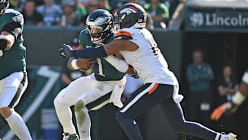 Oct 5, 2025; Philadelphia, Pennsylvania, USA; Philadelphia Eagles quarterback Jalen Hurts (1) is sacked by Denver Broncos linebacker Nik Bonitto (15) at Lincoln Financial Field. Mandatory Credit: Eric Hartline-Imagn Images