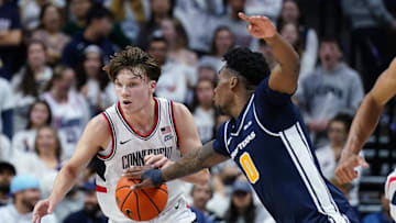 Dec 5, 2025; Storrs, Connecticut, USA; East Texas A&M Lions forward Ronnie Harrison (0) strips the ball from UConn Huskies guard Braylon Mullins (24) in the second half at Harry A. Gampel Pavilion. Mandatory Credit: David Butler II-Imagn Images