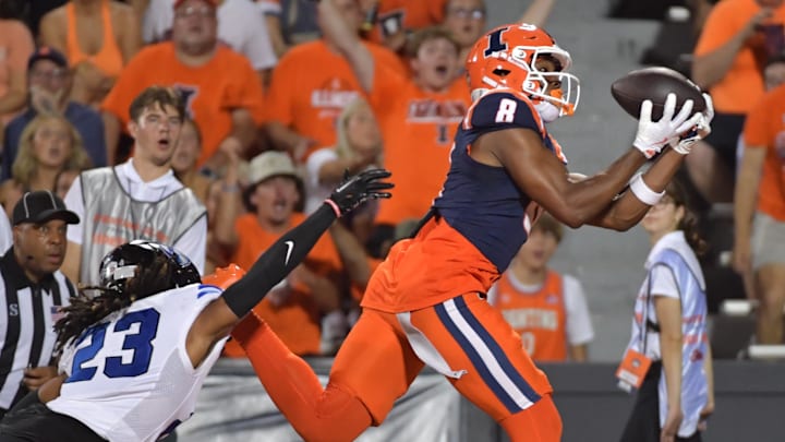 Aug 29, 2024; Champaign, Illinois, USA;  Illinois Fighting Illini wide receiver Malik Elzy (8) catches a touchdown in from of Eastern Illinois Panthers defensive back Isaiah Houi (23) during the first half at Memorial Stadium. 