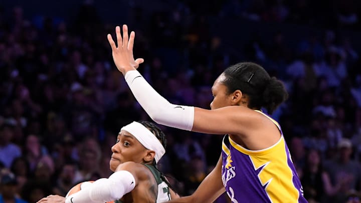 Aug 10, 2025; Los Angeles, California, USA; Seattle Storm guard BrittneySykes (20) drives to the basket as Los Angeles Sparks forward Azura Stevens (23) moves in to defend during the fourth quarter at Crypto.com Arena. Mandatory Credit: Robert Hanashiro-Imagn Images