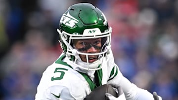 Dec 29, 2024; Orchard Park, New York, USA; New York Jets wide receiver Garrett Wilson (5) runs with the ball after making a catch against the Buffalo Bills in the first quarter at Highmark Stadium. Mandatory Credit: Mark Konezny-Imagn Images
