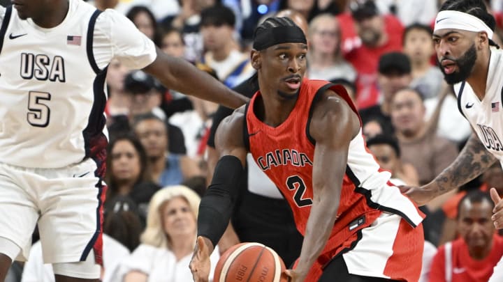 Jul 10, 2024; Las Vegas, Nevada, USA; Canada guard Shai Gilgeous-Alexander (2) looks to make a pass against USA forward Anthony Davis (14) in the first quarter in the USA Basketball Showcase at T-Mobile Arena. Mandatory Credit: Candice Ward-USA TODAY Sports