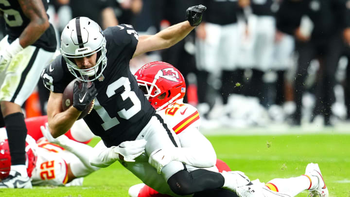 Nov 26, 2023; Paradise, Nevada, USA; Kansas City Chiefs safety Mike Edwards (21) tackles Las Vegas Raiders wide receiver Hunter Renfrow (13) during the third quarter at Allegiant Stadium. Mandatory Credit: Stephen R. Sylvanie-USA TODAY Sports