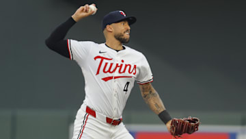 Sep 14, 2024; Minneapolis, Minnesota, USA; Minnesota Twins' Carlos Correa (4) turns a double play against the Cincinnati Reds in the second inning at Target Field. Mandatory Credit: Bruce Kluckhohn-Imagn Images