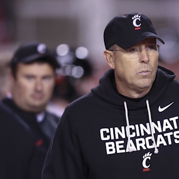 Nov 1, 2025; Salt Lake City, Utah, USA; Cincinnati Bearcats head coach Scott Satterfield watches the teams warm up before the game against the Utah Utes at Rice-Eccles Stadium. Mandatory Credit: Rob Gray-Imagn Images