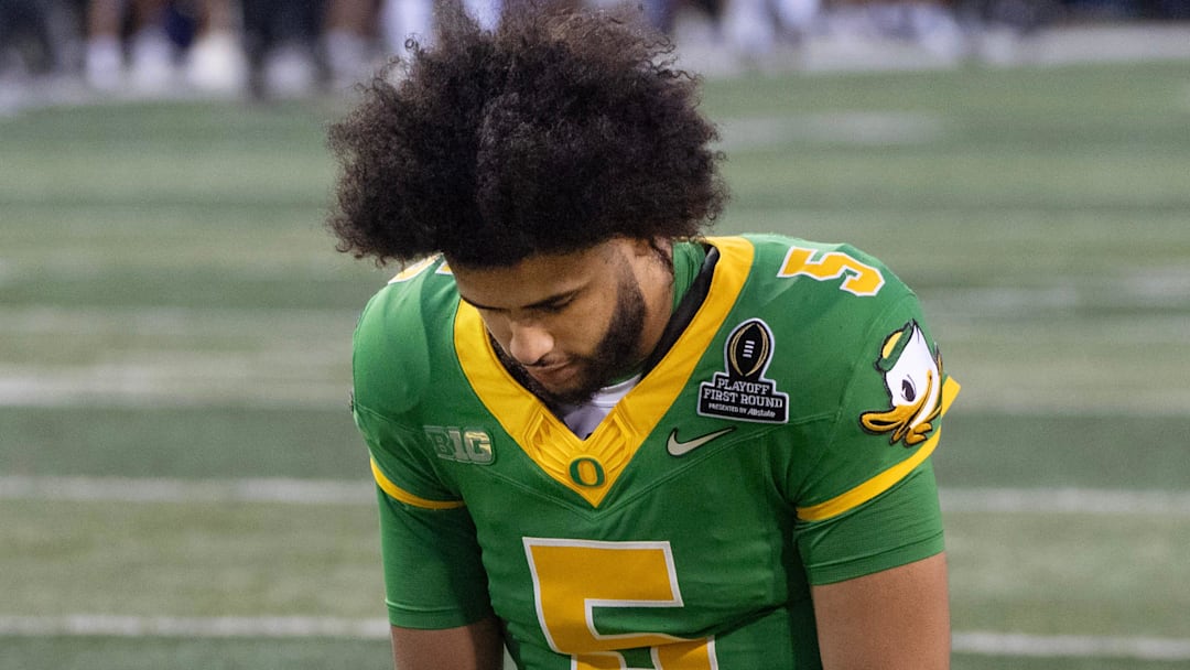 Oregon quarterback Dante Moore bows in prayer before the game against James Madison at Autzen Stadium in Eugene Dec. 20, 2025.